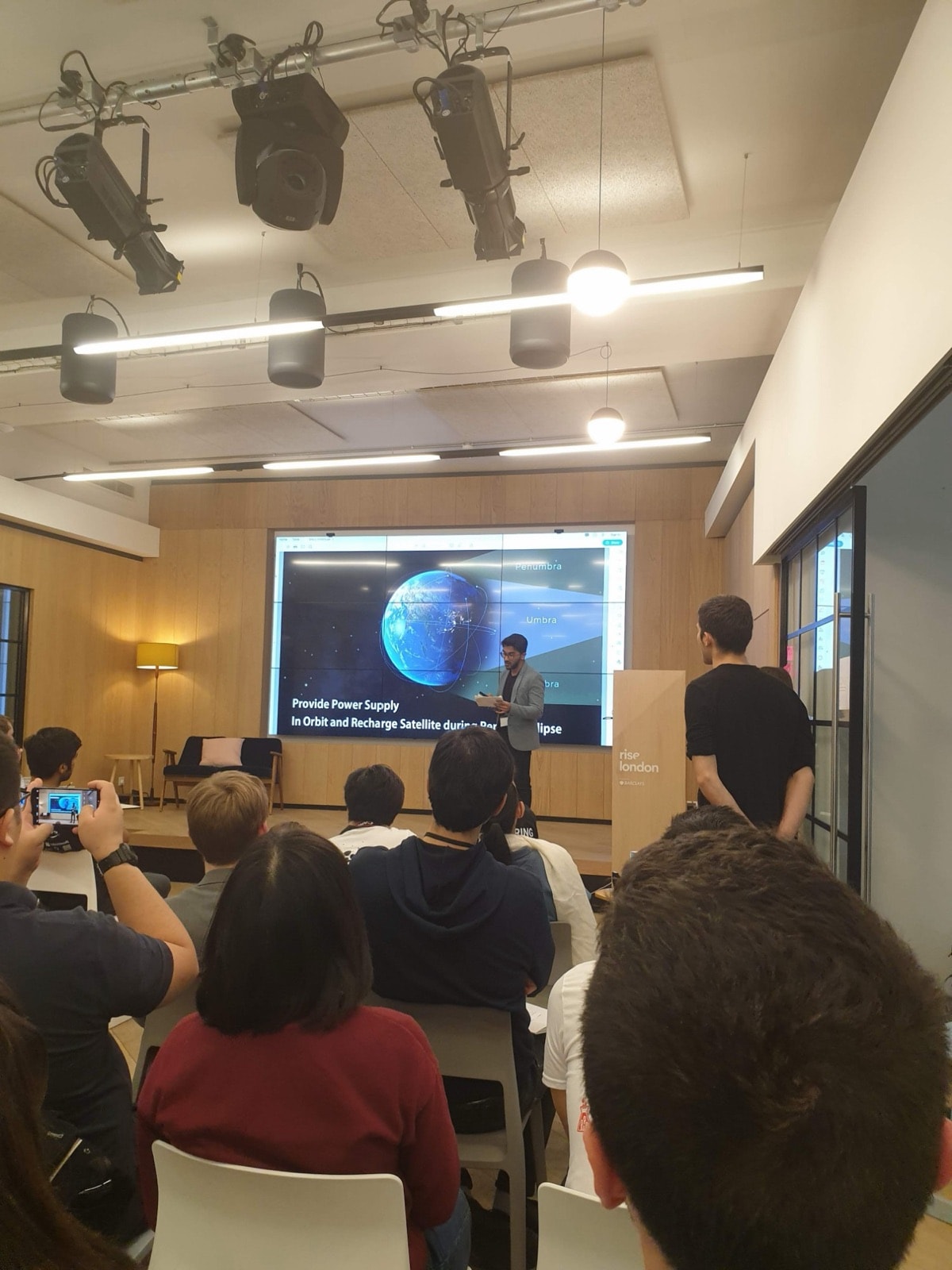 Ricky presenting to an audience at Rise London
